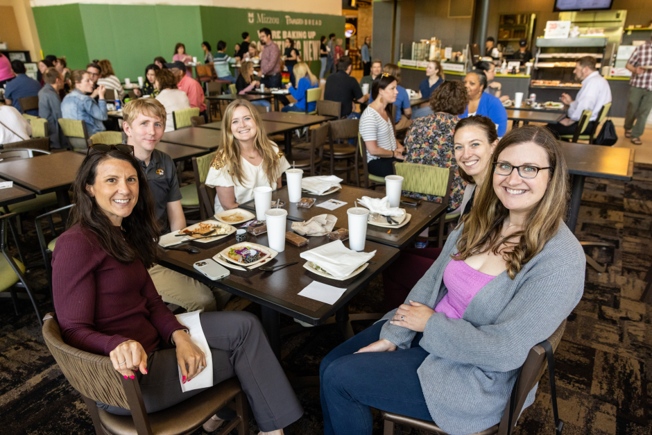 Group poses for camera at table